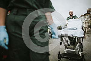 Paramedic team rolling a stretcher on a street