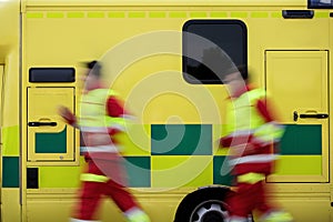 Paramedic team running to ambulance car
