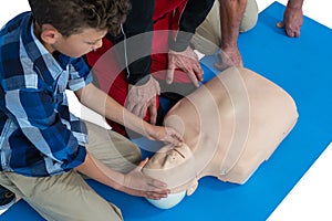 Paramedic training cardiopulmonary resuscitation to boy