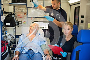 Paramedic treating injured patient in ambulance