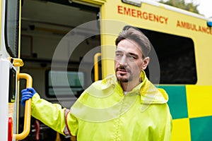 Paramedic in uniform looking away near