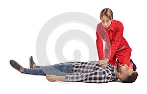 Paramedic in uniform performing first aid on unconscious man against white background