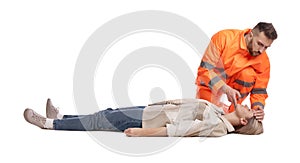 Paramedic in uniform performing first aid on unconscious woman against white background