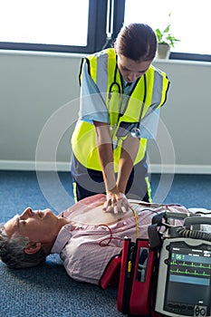 Paramedic using an external defibrillator during cardiopulmonary resuscitation