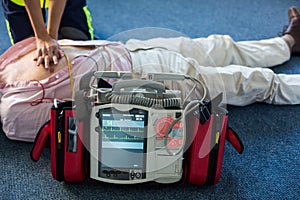 Paramedic using an external defibrillator during cardiopulmonary resuscitation