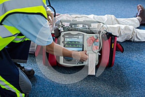 Paramedic using an external defibrillator during cardiopulmonary resuscitation