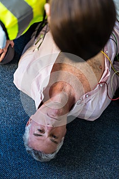 Paramedic using an external defibrillator during cardiopulmonary resuscitation