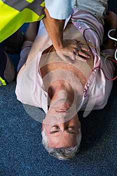 Paramedic using an external defibrillator during cardiopulmonary resuscitation