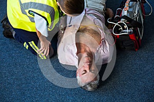 Paramedic using an external defibrillator during cardiopulmonary resuscitation