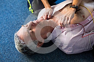 Paramedic using an external defibrillator during cardiopulmonary resuscitation