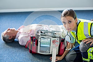 Paramedic using an external defibrillator during cardiopulmonary resuscitation