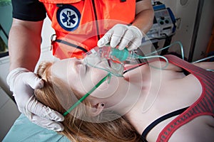 Paramedic using oxygen mask