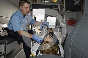 Paramedic With Victim In Ambulance