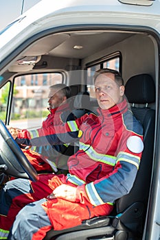 Paramedical personnel seated in a medical emergency vehicle