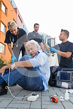 Paramedical team giving firstaid to injured man