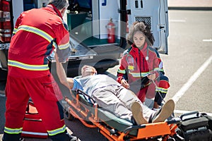 Paramedical workers providing emergency medical care to an accident victim