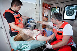 Paramedics applying first aid in ambulance