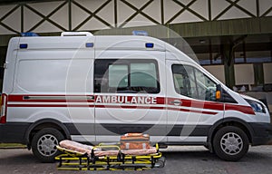 Paramedics emergency rescue team`s stretcher and ambulance car is ready to help photo