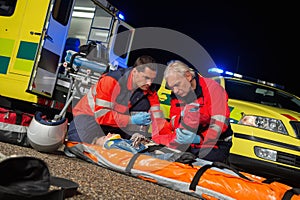 Paramedics giving firstaid to motorbike driver