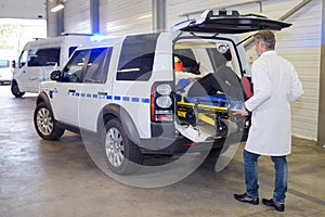 Paramedics offloading patient from ambulance photo