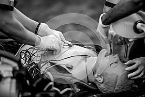 Paramedics perform CPR to a plastic dummy during a public demonstration on how to save a victim