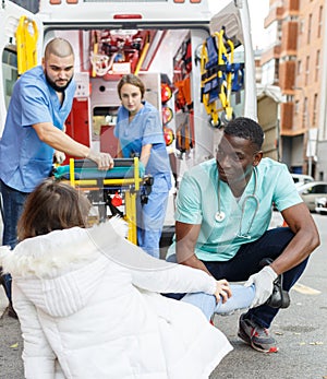 Paramedics providing first aid to woman