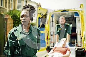Paramedics rolling a patient on a ambulance stretcher photo
