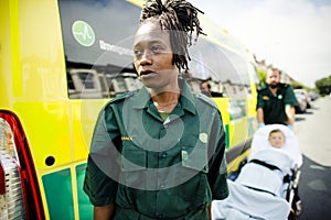 Paramedics rolling a young patient on an ambulance stretcher photo