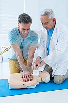 Paramedics training cardiopulmonary resuscitation to man