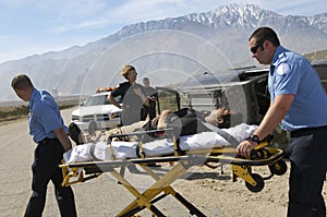 Paramedics Transporting Victim On Stretcher photo