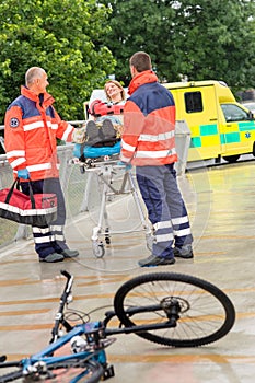 Paramedics with woman on stretcher ambulance aid photo