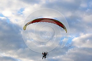 Paramotor flying in a blue sky