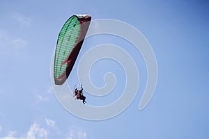 paramotor flying on blue sky