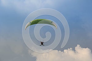 Paramotor flying on the blue sky
