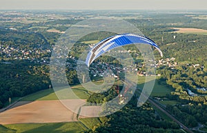 Paramotor flying over a village in France