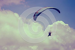 paramotor flying on sky with cloud background