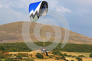 Paramotor pilot flying in to land