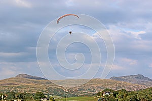 Paramotor pilot flying in Wales