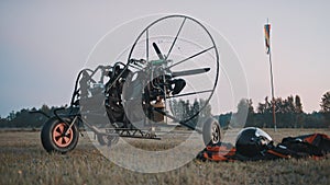 Paramotor and safety clothing and gear on the grass. Paramotorgliding tandem