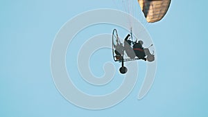 Paramotor trike hanging under parachute in air