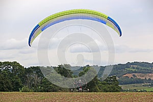 Paramotor trike launching in a field