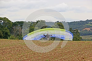 Paramotor trike launching in a field