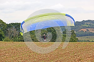 Paramotor trike launching in a field