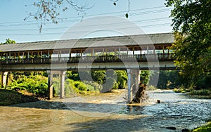 Paranhana river and a view of the covered bridge - a historical landmark in Tres Coroas, Brazil