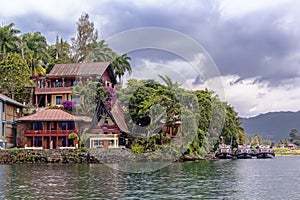 Guest houses in the form of a traditional Indonesian dwelling with a pier for boats on the