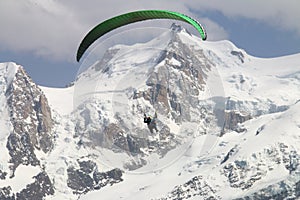Parapenter over french white snowy Mont Blanc massif
