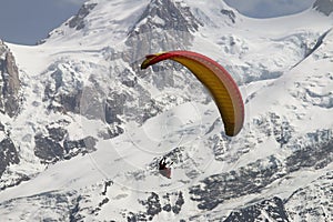 Parapenter over snowy french Mont Blanc massif