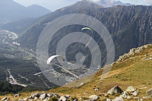 Parapenters at the Aiguille du Midi with Chamonix town spread below