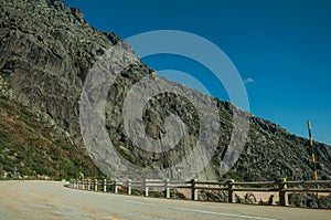 Parapet on edge of road passing through rocky landscape