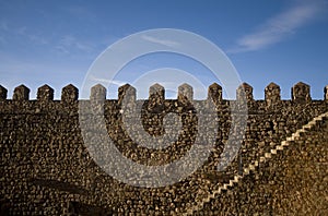 Parapet walk of a fortress. Stairway and merlons.